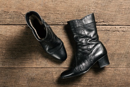 black leather shoes isolated on a wooden plank