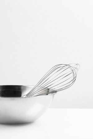 isolated stainless Whisk and stainless bowl on white backgroundの写真素材