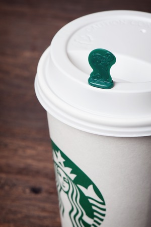 BANGKOK, THAILAND - FEBRUARY 26, 2015: White paper cup with Starbucks logo. Starbucks is the world's largest coffee house with over 20,000 stores in 61 countries.のeditorial素材