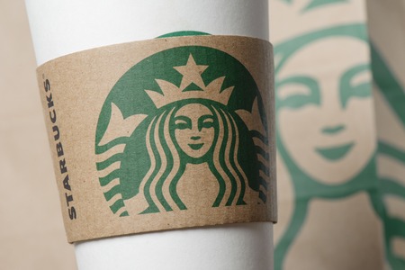 BANGKOK, THAILAND - FEBRUARY 26, 2015: Starbucks logo on sleeve. Starbucks is the world's largest coffee house with over 20,000 stores in 61 countries.のeditorial素材