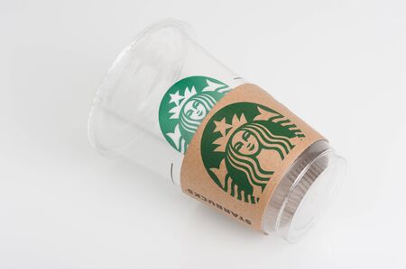 BANGKOK, THAILAND - FEBRUARY 08, 2015: Empty Starbucks coffee plastic cup on white background. Starbucks is the world's largest coffee house with over 20,000 stores in 61 countries.のeditorial素材