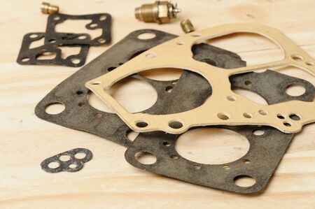 closeup some carburetor parts on wooden deskの写真素材