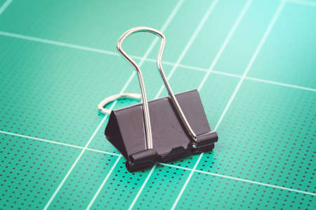 black binder clips isolated on cutting matの写真素材