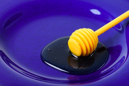 closeup detail of honey and honey dipperの写真素材