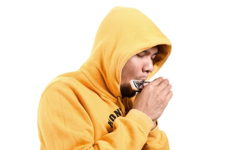 young adult playing the harmonica