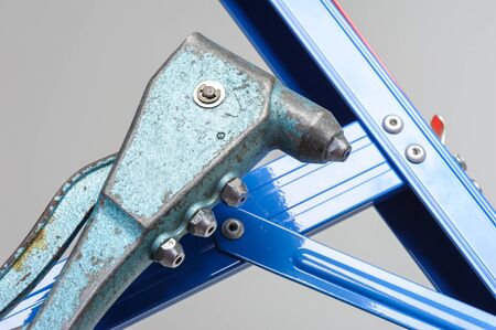 closeup pop rivet gun to fix metal frameの写真素材