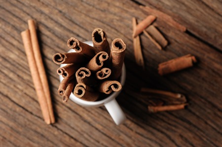 fragrant cinnamon sticks in white cupの写真素材