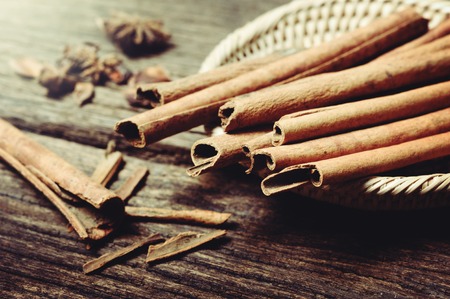 fragrant cinnamon sticks over wooden deskの写真素材