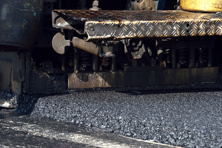 closeup screed of asphalt paver machine during working