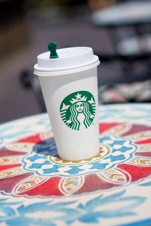 BANGKOK, THAILAND - APRIL 02, 2015: White paper cup with Starbucks logo. Starbucks is the world's largest coffee house with over 20,000 stores in 61 countries.のeditorial素材