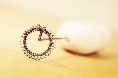 abstract wheel of milk frother on wooden tableの写真素材