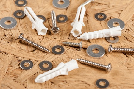 Closeup heap of screw, pad screw washer and plastic straddling dowelの写真素材