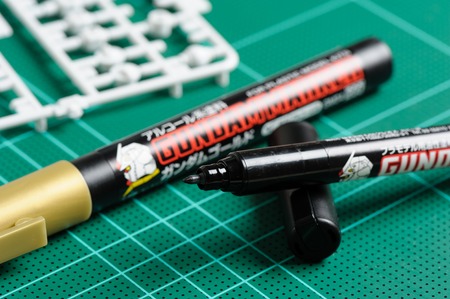 BANGKOK, THAILAND - AUGUST 06, 2015: The Gundam Marker (marker for plastic model kits) on cutting mat.のeditorial素材