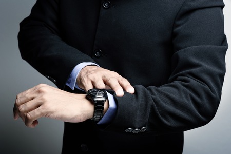 businessman looking the watch on his wristの写真素材