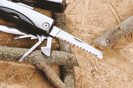 using handsaw cutting the branch