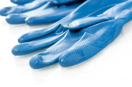 wet blue rubber glove isolated on white backgroundの写真素材