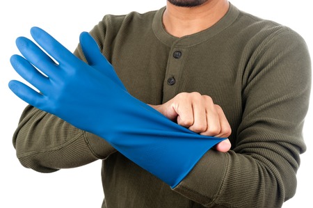 The man wearing blue rubber glove to protect his hand