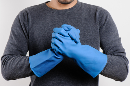 The man's hands in blue rubber gloves ready to cleaning.