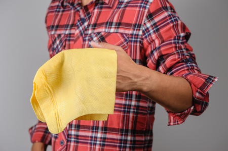 yellow PVA chamois for car cleaning in man's handの写真素材