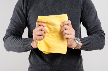 yellow PVA chamois for car cleaning in man's handの写真素材