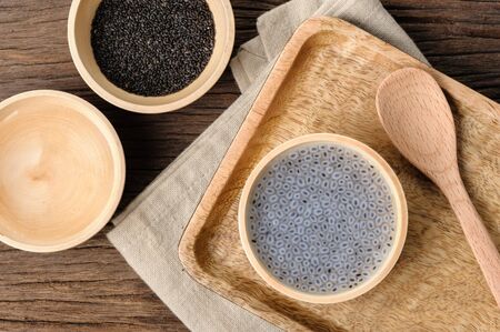 closeup sweet basil seeds in the wooden bowlの写真素材