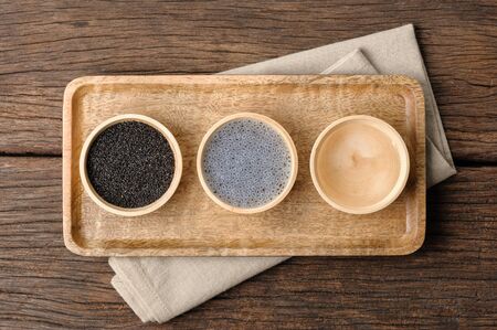closeup sweet basil seeds in the wooden bowlの写真素材