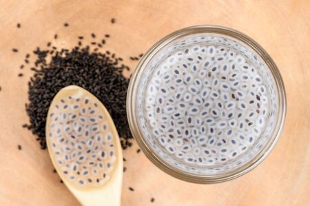 closeup sweet basil seeds in the glassの写真素材