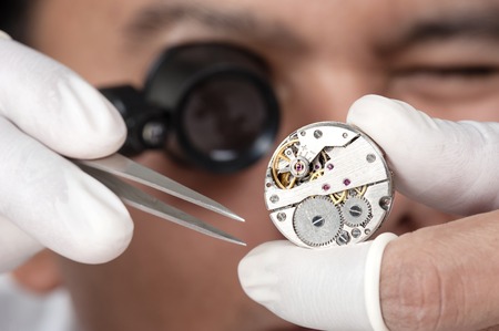 watchmaker repairing the automatic wristwatchの写真素材