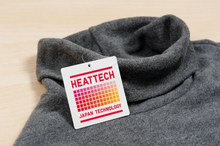 BANGKOK, THAILAND - NOVEMBER 16, 2015: Closeup HEATTECH tag on Uniqlo product. HEATTECH provides thermal insulation by converting the vapor generated by the body into heat.のeditorial素材
