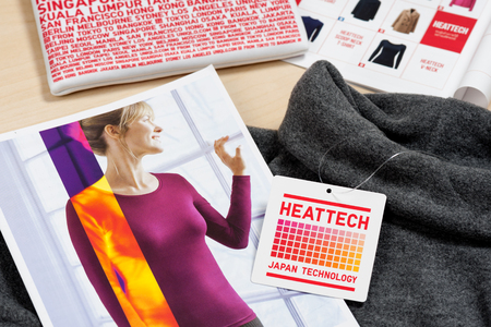 BANGKOK, THAILAND - NOVEMBER 16, 2015: Closeup HEATTECH tag on Uniqlo product. HEATTECH provides thermal insulation by converting the vapor generated by the body into heat.のeditorial素材
