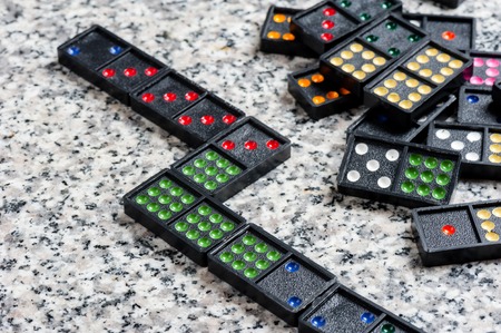 Dominoes. Dominoes is a game played with rectangular domino tiles.