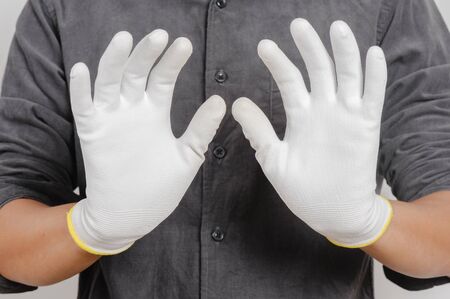 Electrician wear the antistatic gloves to protect an electrical components from damage.
