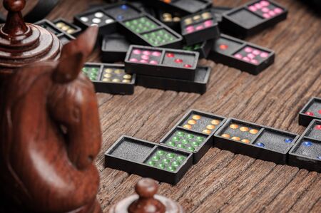 Dominoes. Dominoes is a game played with rectangular domino tiles.