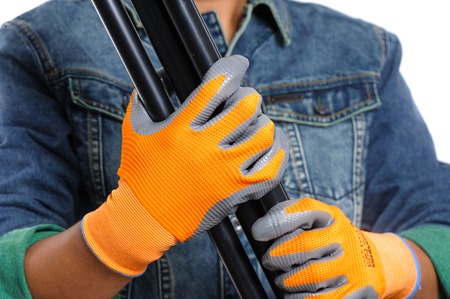 Closeup all purpose gloves with non-slip rubber coated on woker's hand.