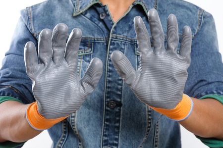 Closeup all purpose gloves with non-slip rubber coated on woker's hand.の写真素材