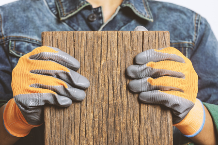 Closeup all purpose gloves with non-slip rubber coated on woker's hand.の写真素材