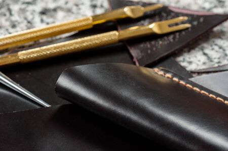 leather working, closeup details of black leatherの写真素材