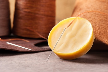 The beeswax and the needle for hand stitching leatherの写真素材