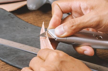 Using the retractable utility knife to cut leather