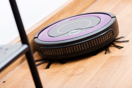 robotic vacuum cleaner cleaning the dirty floorの写真素材