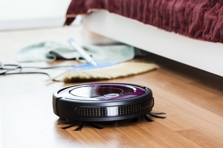 robotic vacuum cleaner cleaning the roomの写真素材
