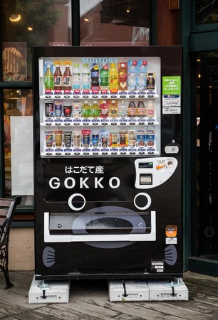 HOKKAIDO, JAPAN - JULY 19, 2015: Japanese soft drink vending machine at side of the road in Motomachi district. .Japan is famous for its vending machines, with more than 5.5 million machines nationwide.のeditorial素材