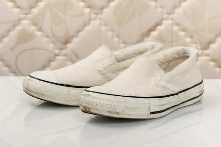closeup white women canvas sneakers without laces