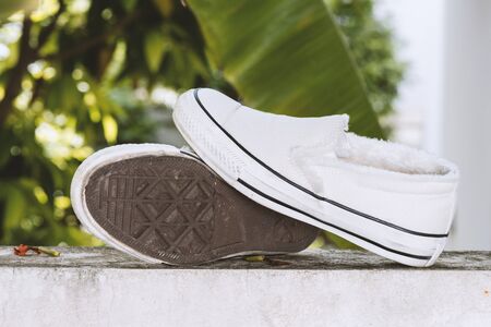 white women sneakers without laces in the garden