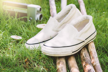 white women sneakers without laces in the gardenの写真素材