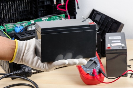 Technician replacing the UPS(Uninterruptible Power Supply) battery.
