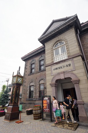 HOKKAIDO, JAPAN - JULY 21: 2015: The facade of Music Box Museum which has a vintage steam clock tower in front.のeditorial素材