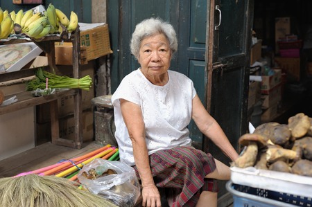 CHACHOENGSAO, THAILAND - JUNE 21, 2014: An unidentified market women waiting for customers at Talat Klong Suan Roi Pi (100 year-old Klongsuan Market).のeditorial素材