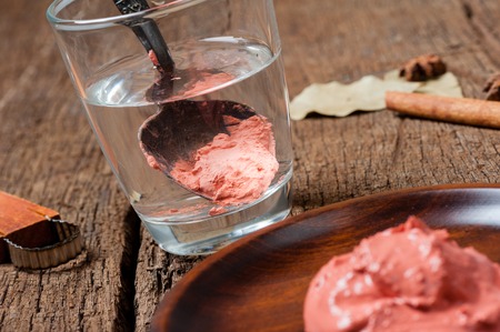 Limestone solution. Limestone solution is limestone paste mixed with water and left undisturbed to allow the limestone particles to settle at the bottom often used in Thai food.の写真素材