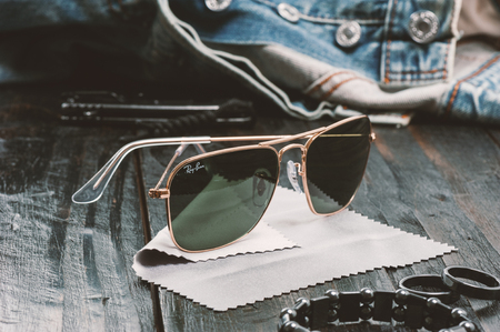 BANGKOK, THAILAND - AUGUST 24, 2016: The Ray-Ban Caravan with gold frame and classic G-15 Lens. Ray-Ban is a brand of sunglasses and eyeglasses founded in 1937 by American company Bausch & Lomb.のeditorial素材